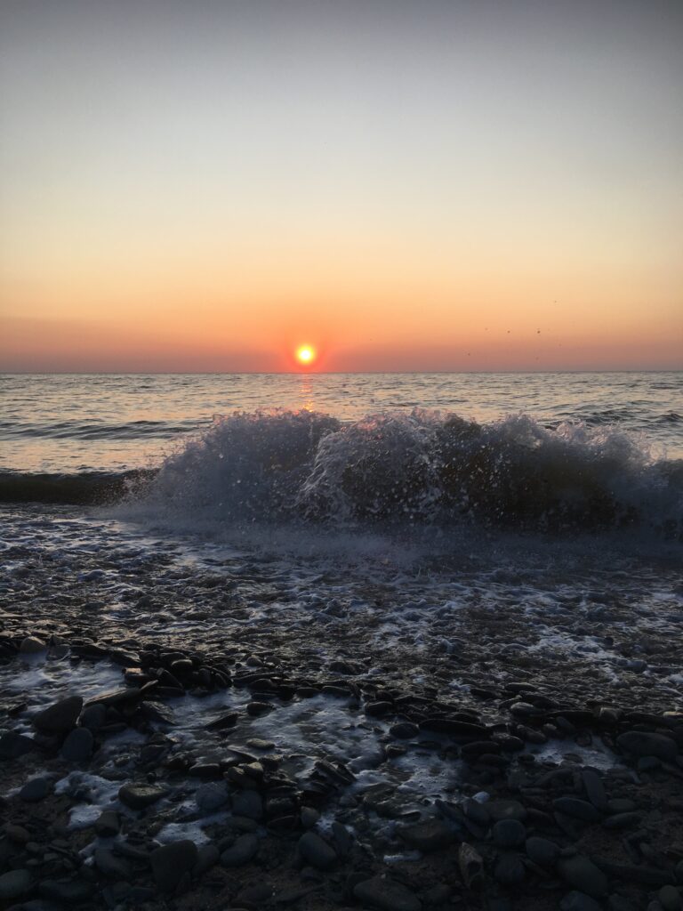 Earth, Air, Fire and Water seen on a beach at sunset