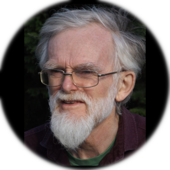 a photograph of Author A G Rivett who has greying hair and beard, and wears glasses.